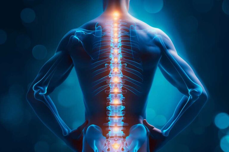 A patient performs guided therapeutic exercises while a clinician discusses spinal mobility and movement technique.